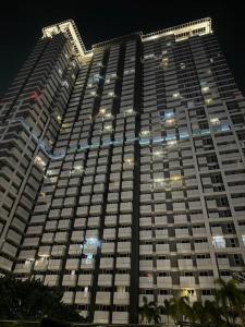 a large building at night with lights at West Vista Studio Apartment with Netflix in Jakarta