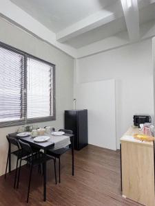 a kitchen with a table with chairs and a refrigerator at Tolomhouse in Hat Yai +31 photos