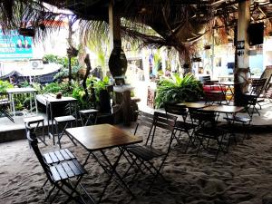 a group of tables and chairs in a restaurant at Spicy23 - M' Pai Bay in Sihanoukville