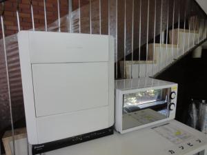 a white machine sitting on a table next to a staircase at Tottori City Hotel / Vacation STAY 81349 in Tottori