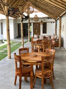 a wooden table and chairs in a pavilion at NOMAD Tropical Hostel Canggu in Dalung