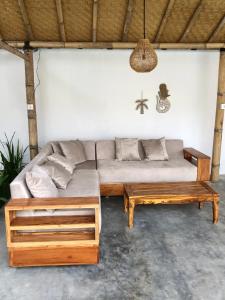 a living room with a couch and a table at NOMAD Tropical Hostel Canggu in Dalung
