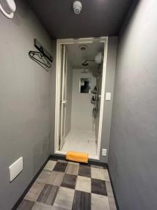 a bathroom with a shower with a yellow towel on the floor at Rhodes Otsuka Hotel in Tokyo +57 photos