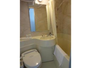 a bathroom with a toilet and a sink and a tub at Tottori City Hotel / Vacation STAY 81354 in Tottori +8 photos