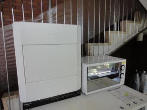 a white machine sitting on a table next to a staircase at Tottori City Hotel / Vacation STAY 81356 in Tottori