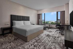 a hotel room with a bed and a desk at Crowne Plaza Shanghai Jinshan, an IHG Hotel in Jinshan