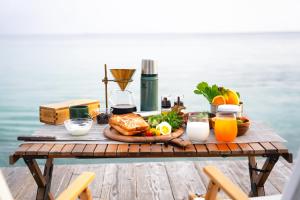 un tavolo da picnic con vassoio di cibo e succo d'arancia di ASOBI HACK 
