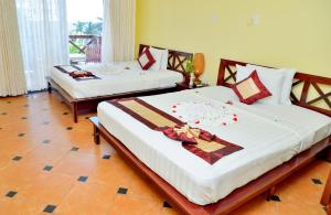 Кровать или кровати в номере Thai Hoa Mui Ne Resort