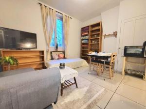 a living room with a couch and a table at Apartment close to Lyon and Parc de Parilly in Saint-Priest