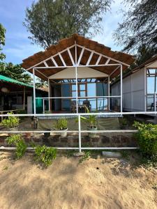 a house with a pavilion in front of it at Mountain Palm patnem beach in Patnem