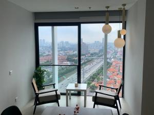 a room with two chairs and a table and a large window at 3 Bedroom Condominium in LUMI TROPICANA in Petaling Jaya