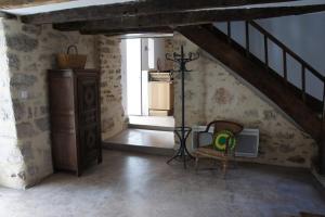 Zimmer mit einer Treppe, einem Tisch und einem Stuhl in der Unterkunft Maison de village rénovée in Meyronne