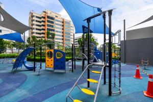 a playground with a blue and yellow slide at 3 Bedroom Condominium in LUMI TROPICANA in Petaling Jaya