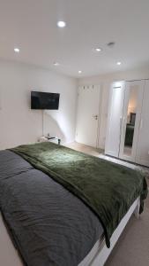 a bedroom with a large bed and a flat screen tv at Ferienwohnung an der Dhron in Neumagen-Dhron