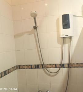 a shower with a shower head in a bathroom at Sunrise Guesthouse and Inn, Panglao in Panglao Island