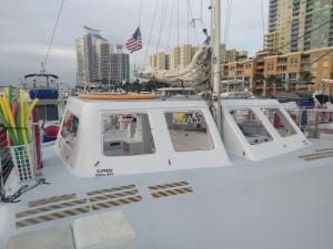 a white boat is docked in a harbor at Mariah Catamaran in Miami Beach