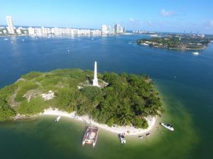 an island in the water with a lighthouse on it at Mariah Catamaran in Miami Beach
