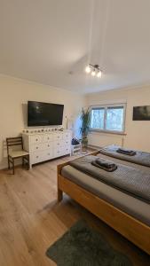 ein Schlafzimmer mit zwei Betten und einem Flachbildfernseher in der Unterkunft Ferienhaus Dhrontal in Neumagen-Dhron + 24 Fotos