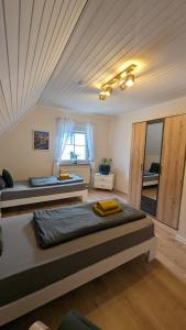 two beds in a room with a ceiling at Ferienhaus Dhrontal in Neumagen-Dhron