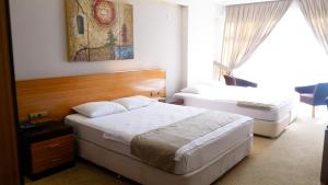 Un pat sau paturi într-o cameră la Hotel La Bella Salihli