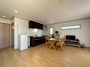 uma cozinha e sala de jantar com mesa e cadeiras em Shirahama Yamate Rent Villa A-2-3 em Shirahama
