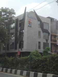 a building with a painting of a person on it at Travellers Hotel in New Delhi