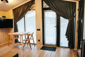 a room with a table and a large window at Bereg holiday park in Svetlogorskoye