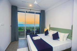 a bedroom with a bed with a view of the ocean at Villa beachcomber in Ambalangoda