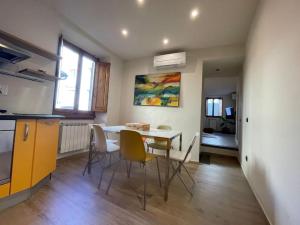 サン・カシャーノ・イン・ヴァル・ディ・ペーザにある“Casa Torre” nel cuore di San Cascianoのテーブルと椅子のあるキッチンとダイニングルーム +15枚の写真