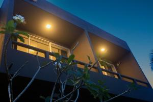 a blue building with two windows at night at Villa beachcomber in Ambalangoda