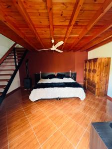 a bedroom with a bed with a ceiling fan at Los Velitos in Santa Rosa del Conlara