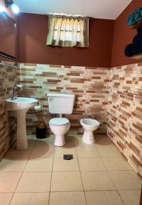a bathroom with a toilet and a sink at Los Velitos in Santa Rosa del Conlara