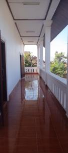 an empty hallway with white walls and a large window at 阳光客栈 in Luang Prabang