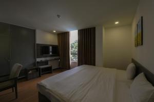 a hotel room with a bed and a television at Chiic House 5 - Khách sạn tình yêu in Nha Trang