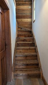 a staircase in a house with wooden floors and a door at Alpenpanorama Ovronnaz in Ovronnaz