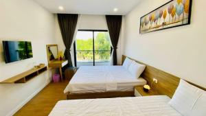 Ένα ή περισσότερα κρεβάτια σε δωμάτιο στο Ruby Homestay