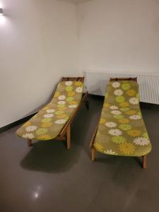 two beds in a room with flowers on them at Apartament Czarna Góra NATALIA in Stronie Śląskie