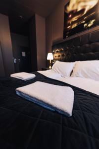 two beds in a hotel room with two white towels on them at Brim Hotel in Reykjavík