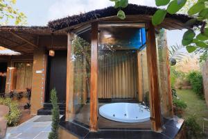 a bath tub in the middle of a house at Nature Village Resort in Pushkar