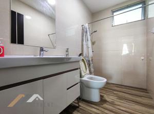 a bathroom with a toilet and a sink at Serene Heights by Evernent in Miri