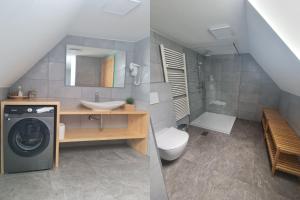 a bathroom with a sink and a washing machine at Chalet Pokljuka in Goreljek