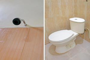 a bathroom with a white toilet and a black fan at OYO 91707 Jannah Homestay Syariah in Dau