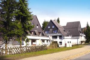 a row of white houses with black roofs at Apartment, Hahnenklee in Hahnenklee-Bockswiese