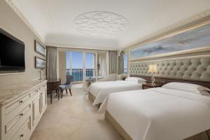 a hotel room with two beds and a television at Crowne Plaza Resort Sanya Bay, an IHG Hotel in Sanya