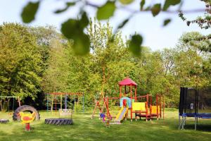 a playground with colorful equipment in a park at Cottages at the Kummerower See, Verchen in Verchen