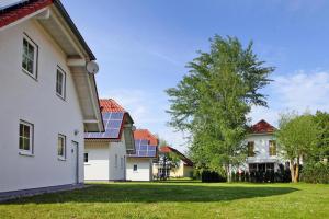 a row of houses with solar panels on their roofs at Cottages at the Kummerower See, Verchen in Verchen