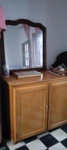 a mirror on top of a wooden dresser with a laptop on it at My house in Rabat