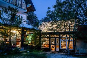 a building with a lot of windows in front of it at Shepherd's hut in nature in Vojnić