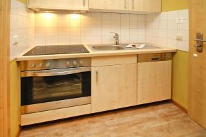 a kitchen with a sink and a stove at Wohnung in Plau am See in Plau am See