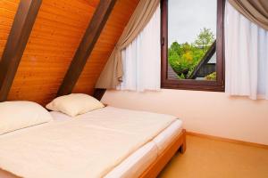 two beds in a room with a window at Holiday park Immenstaad - DBE02005-FYC in Immenstaad am Bodensee